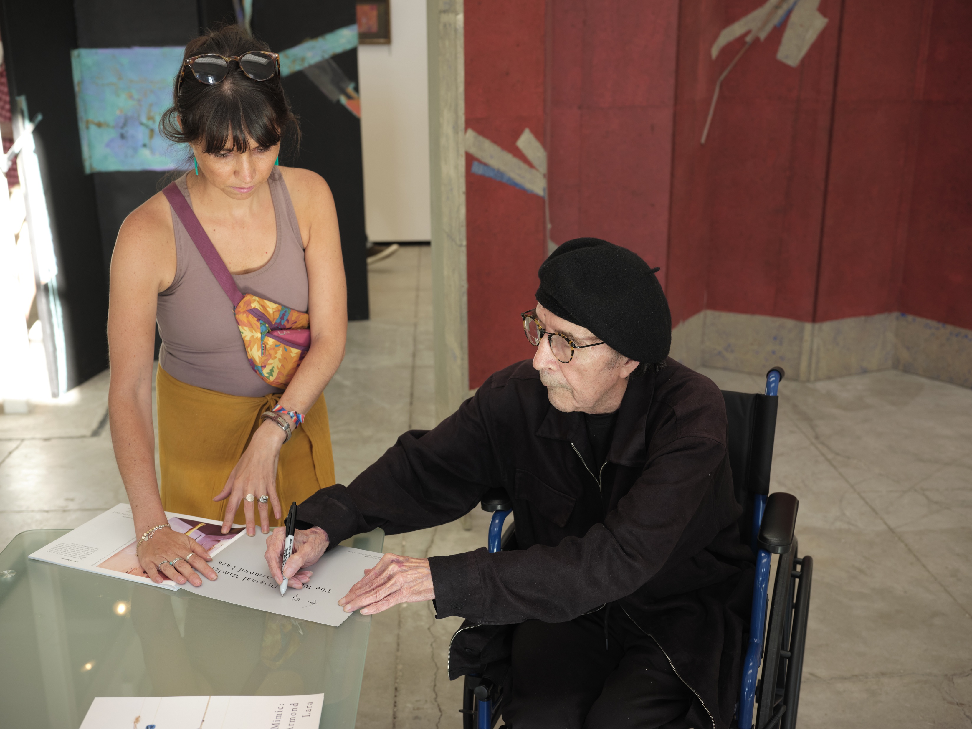 Armond Lara autographing a book