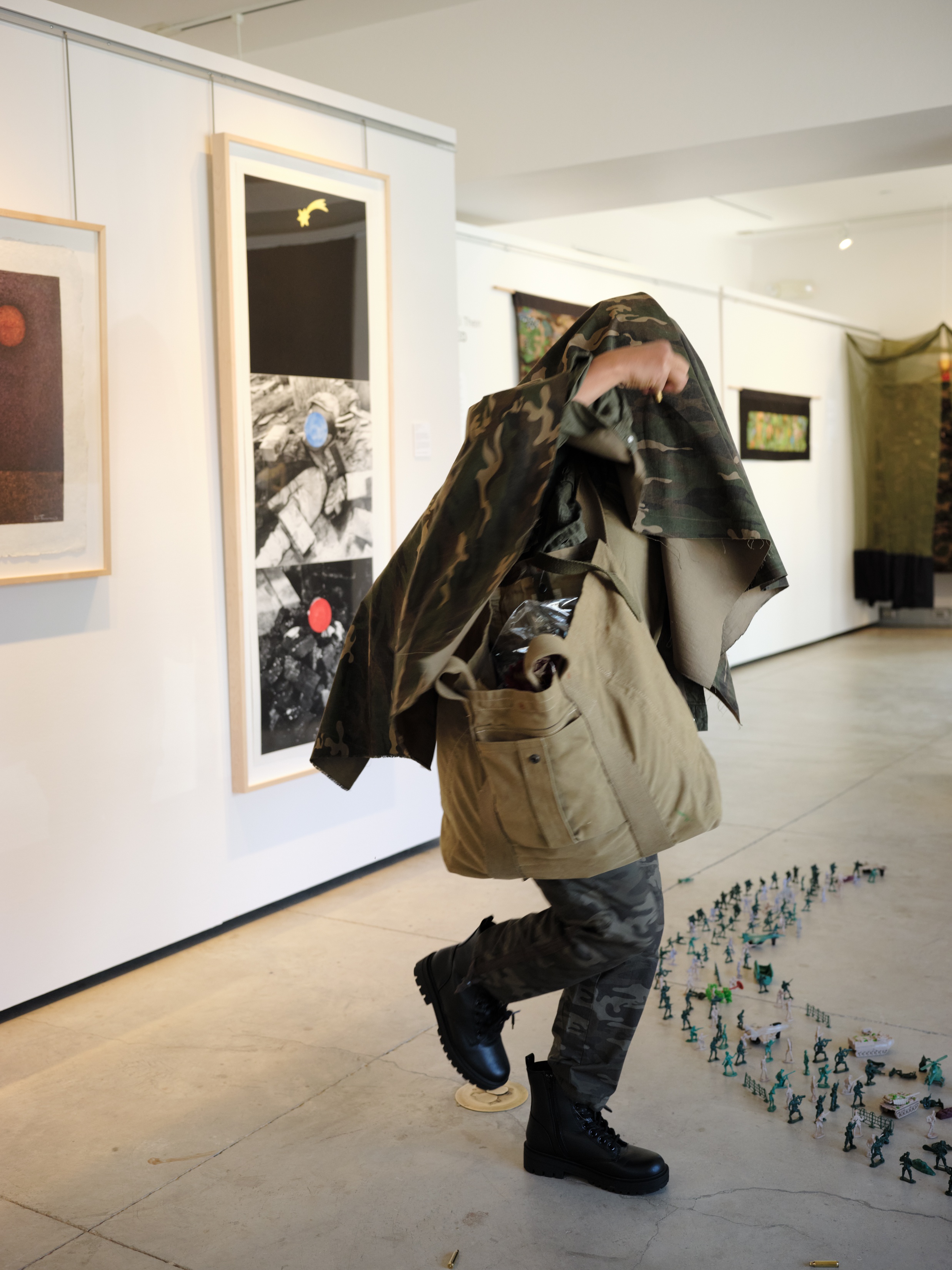 Artist shrouded in camouflage garb
