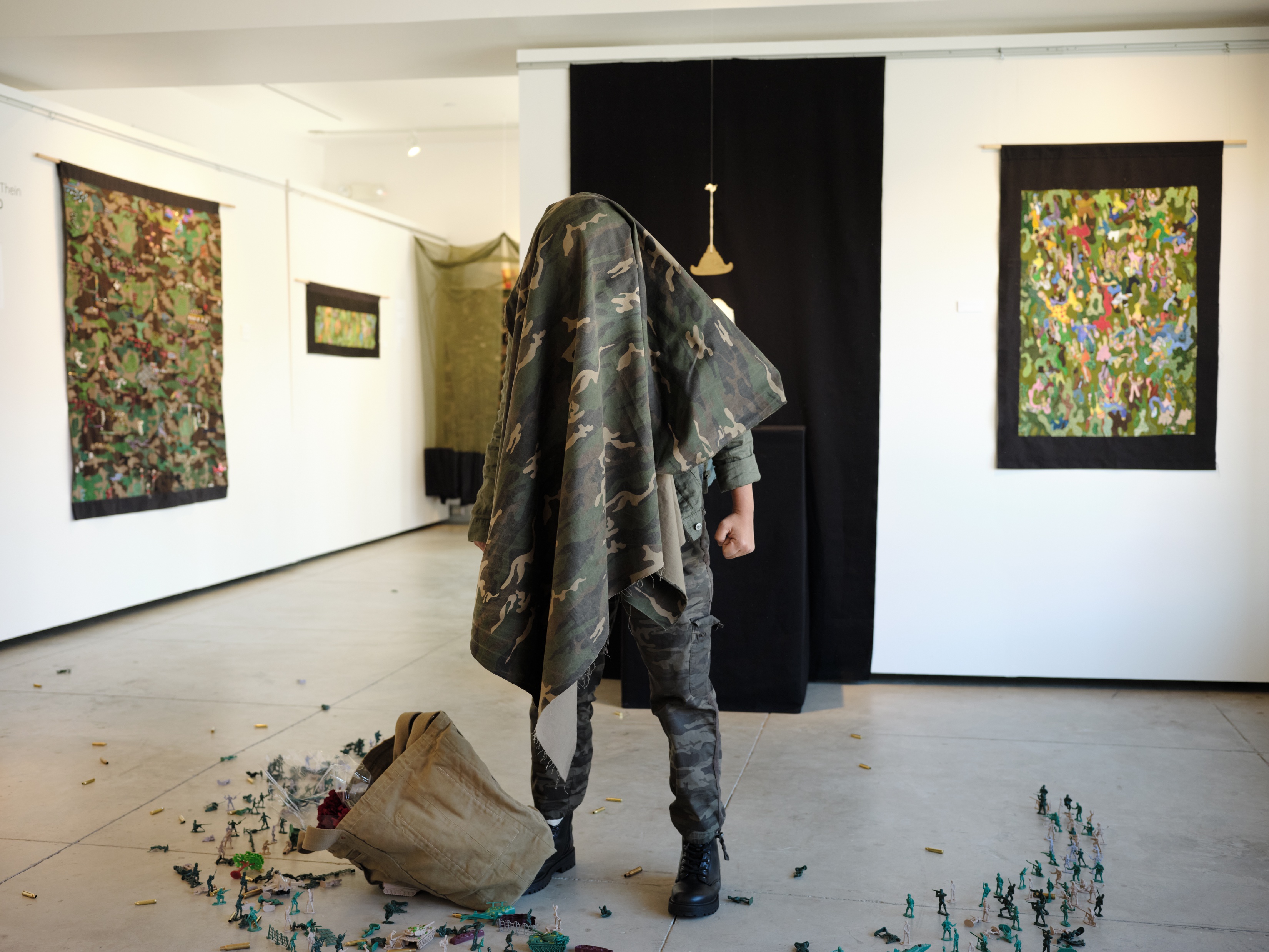 Artist shrouded in camouflage garb