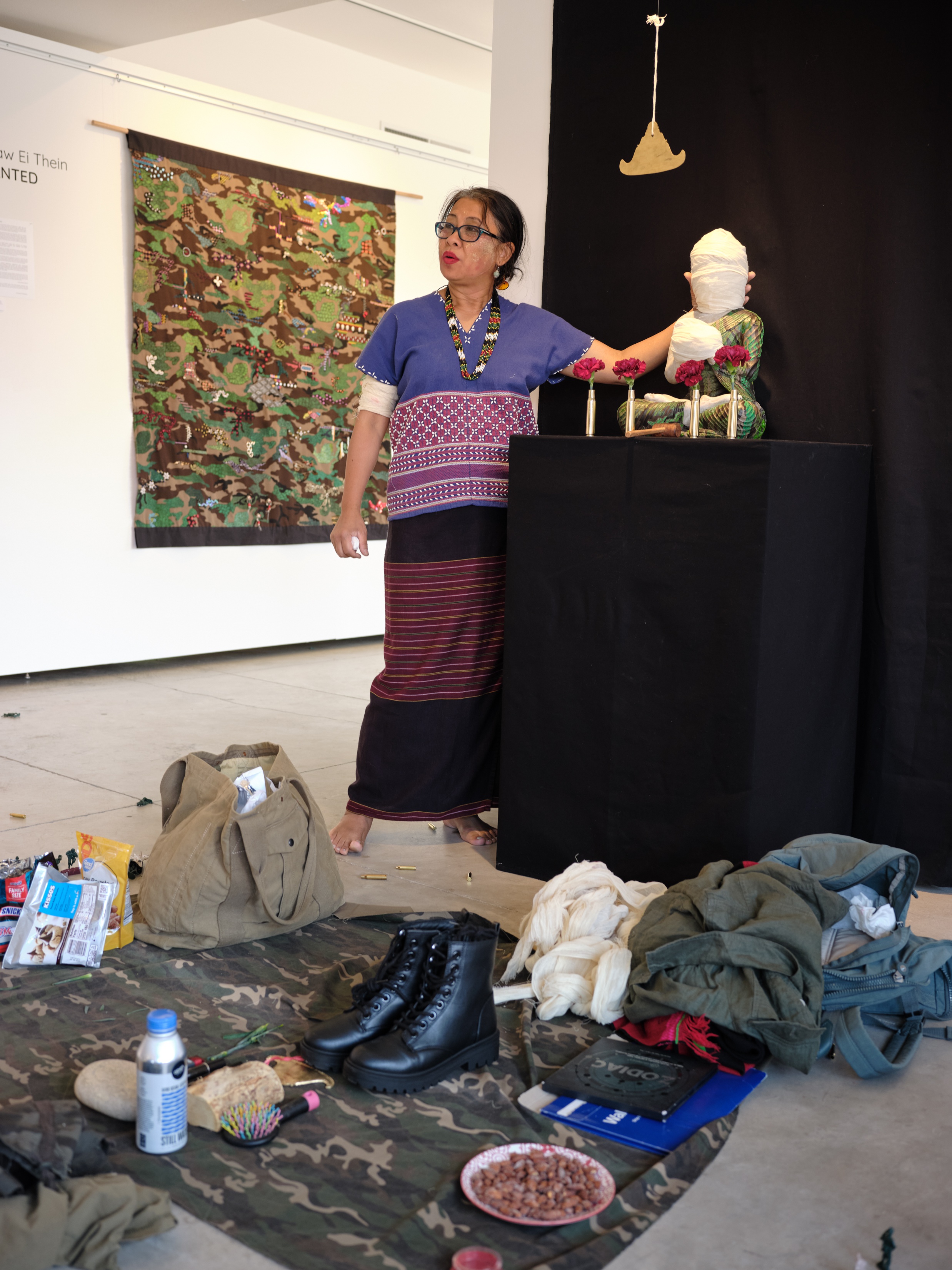 Artist standing next to Buddhist statue